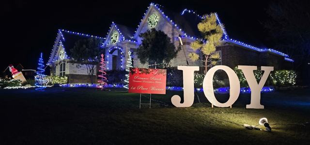 Blue and white roofline with joy yard sign